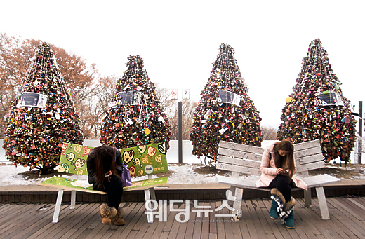 17일 서울 용산구 남산공원 N서울타워에서 두 여성이 사랑의 자물쇠 앞 벤치에 각각 앉아 스마트폰을 사용하며 누군가를 기다리고 있다. 이기태 기자 likitae@ibabynews.com ⓒ베이비뉴스