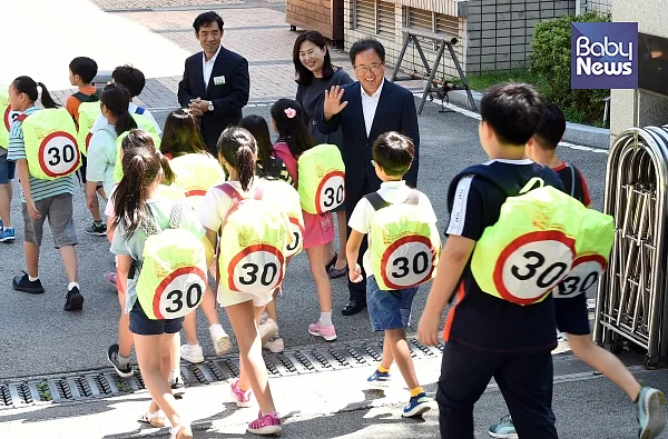 김석준 부산광역시교육감이 5일 오전 10시30분 창신초등학교 대강당에서 빈대인 BNK부산은행장, 이수경 초록우산어린이재단 부산지역본부장, 이 학교 학생과 교직원 등이 참석한 가운데 열린 ‘가방 안전덮개’ 전달식을 가진 후 교문에서 가방덮개를 착용한 학생들을 맞이하고 있다. ⓒ부산광역시교육청