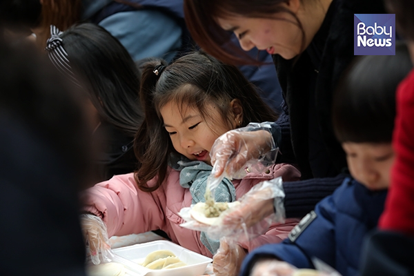 조금 추운 날씨에도 시장에서 한 아이가 즐거운 표정으로 만두를 빚고 있다. 김재호 기자 ⓒ베이비뉴스