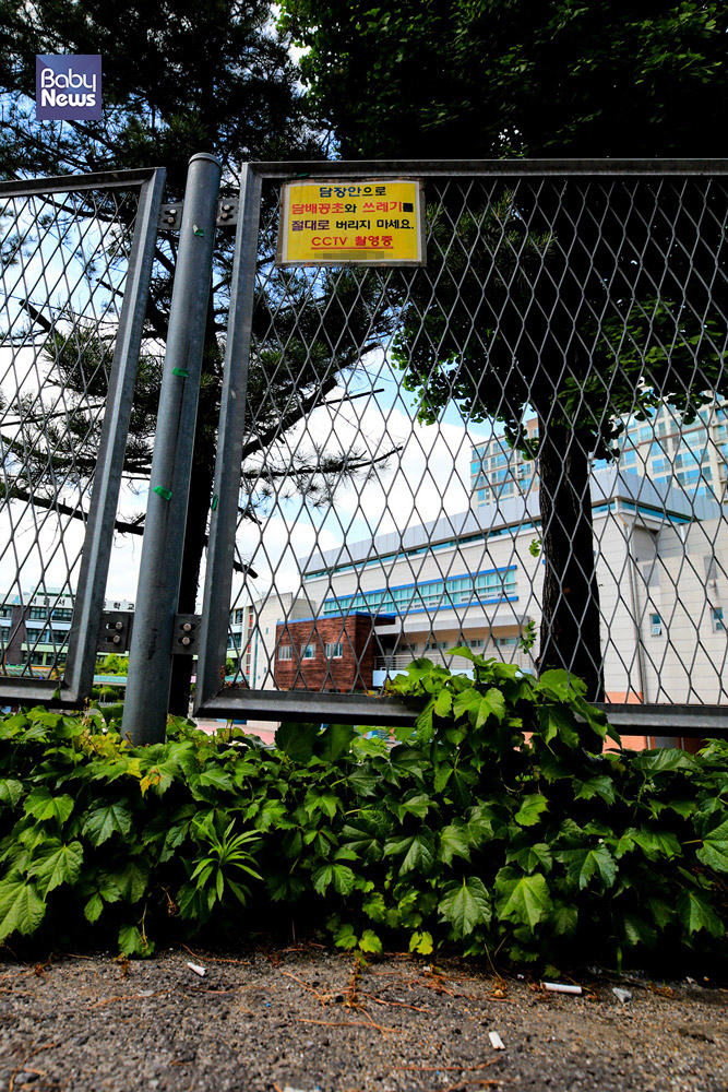 20일 오후 서울의 한 초등학교 담장에 담배꽁초를 안으로 버리지 말라는 안내문이 붙어있고 그 앞에서 흡연을 한 담배꽁초들이 버려져있다. 김재호 기자 ⓒ베이비뉴스